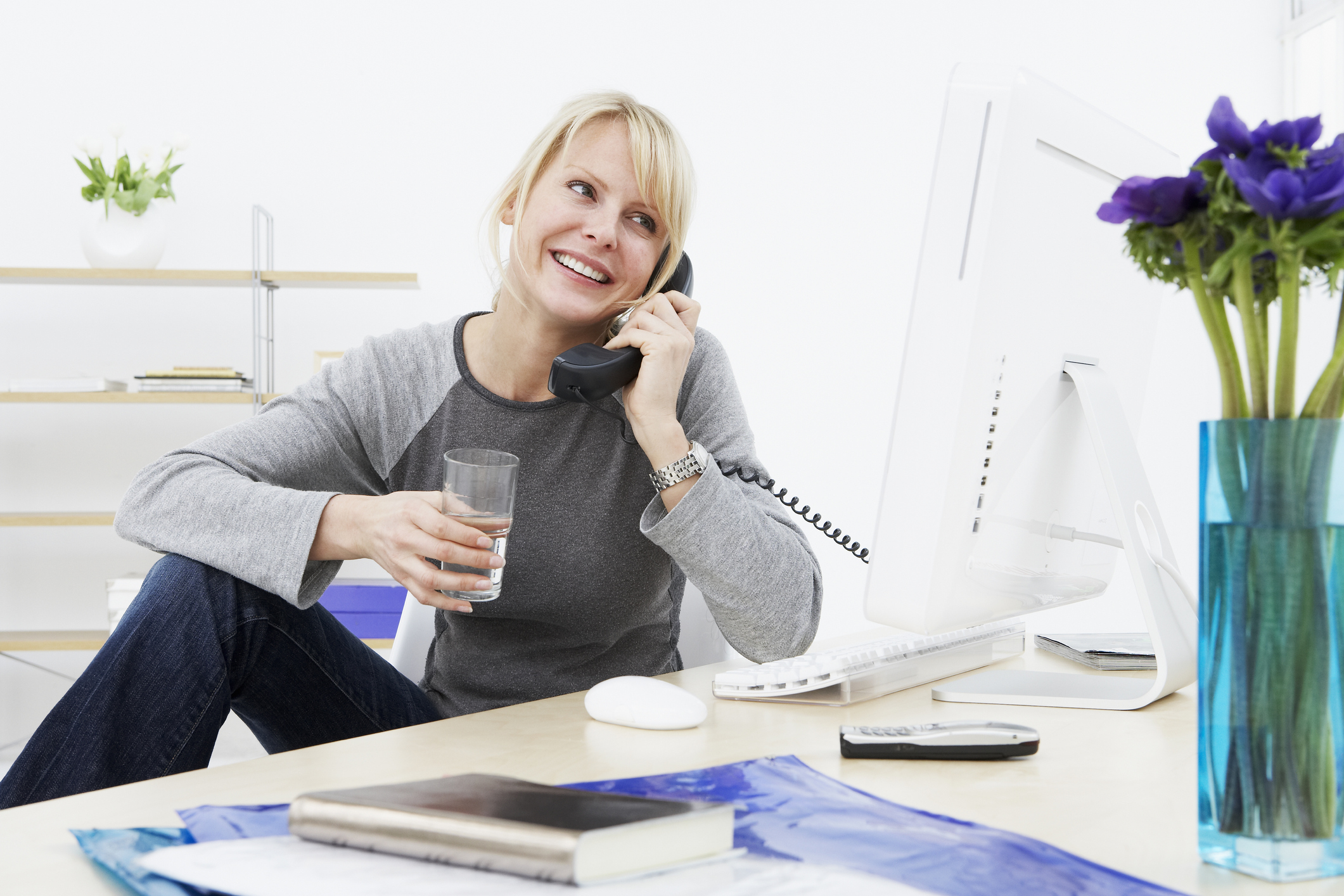 Businesswoman talking on phone at work.