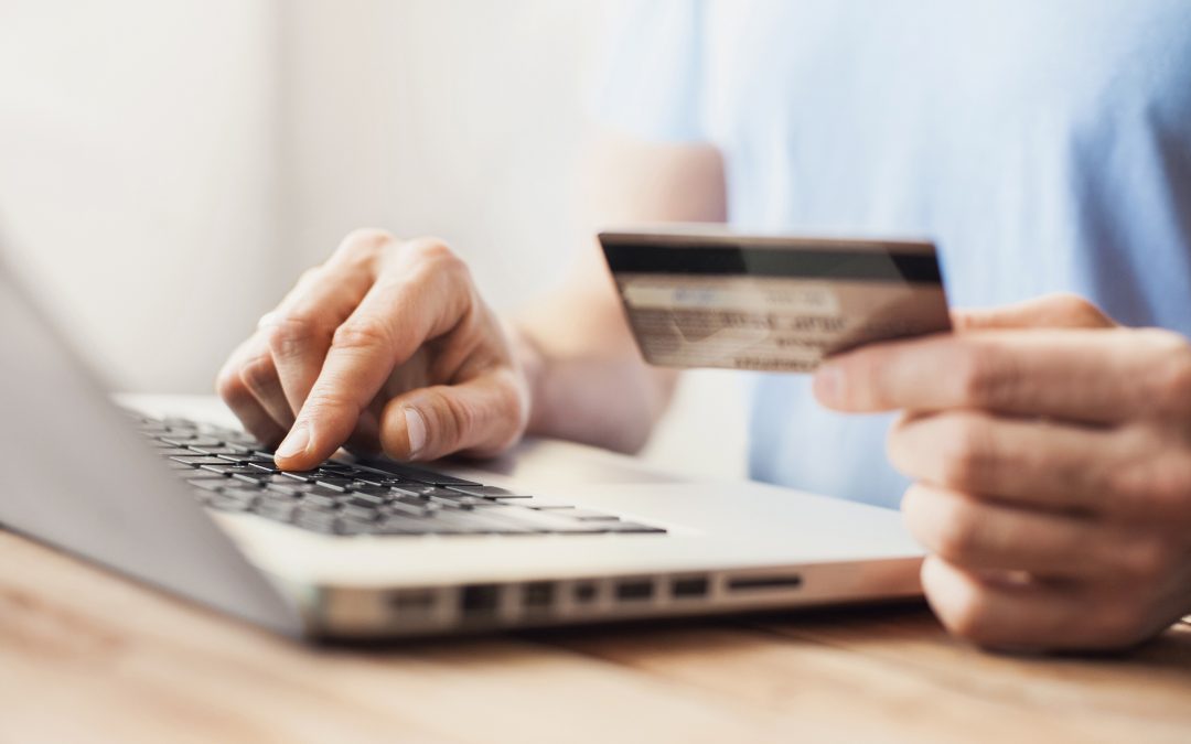 Young man shopping with credit card and laptop computer